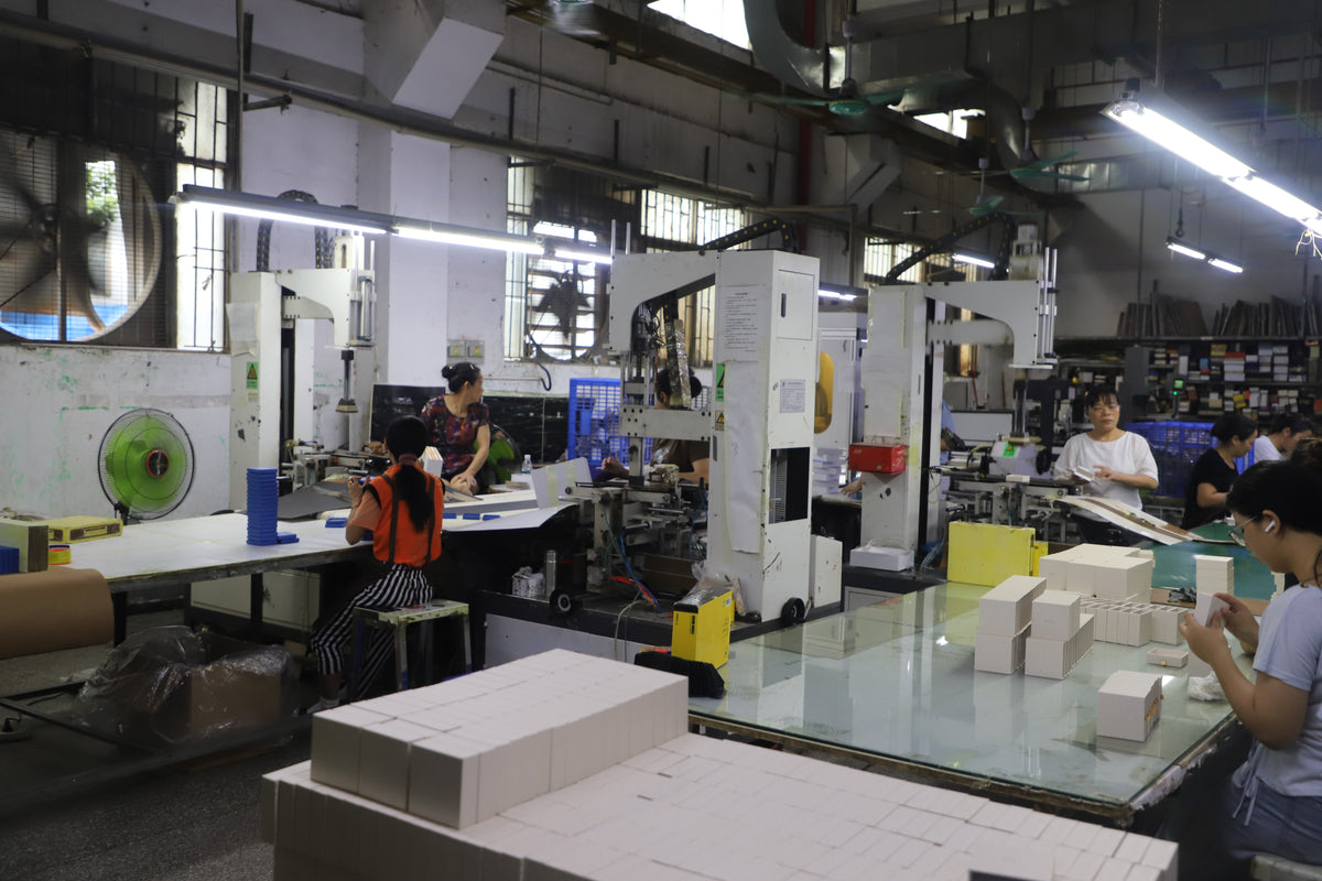 rigid paper box manufacturing workshop with automatic forming machines