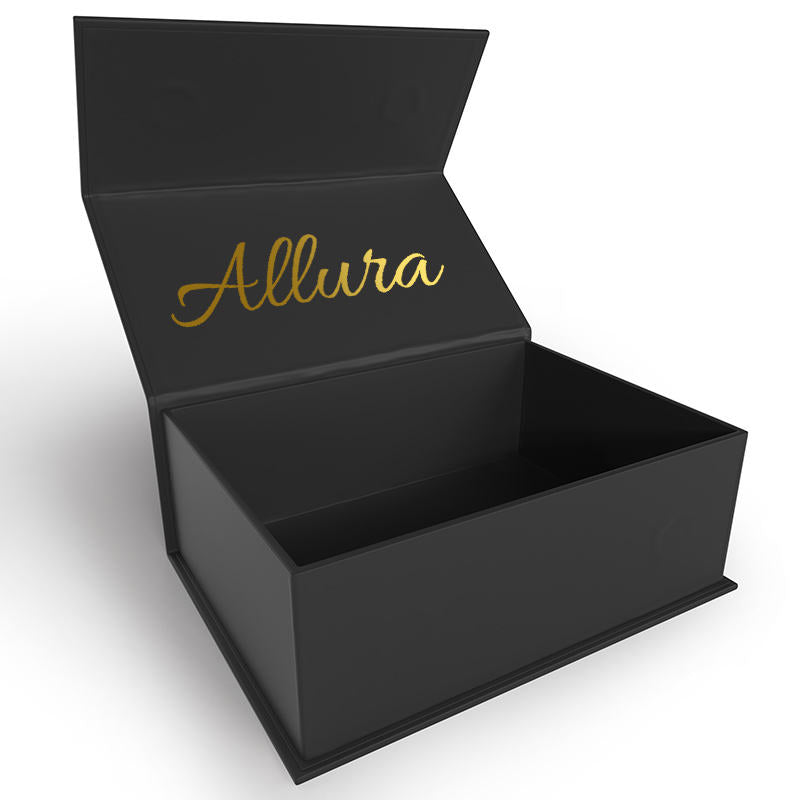 Open black hinged gift box with gold script branding on the inside lid.