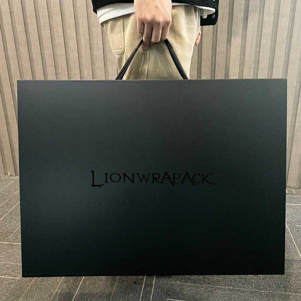 Black paper shopping bag with black handles and centered logo