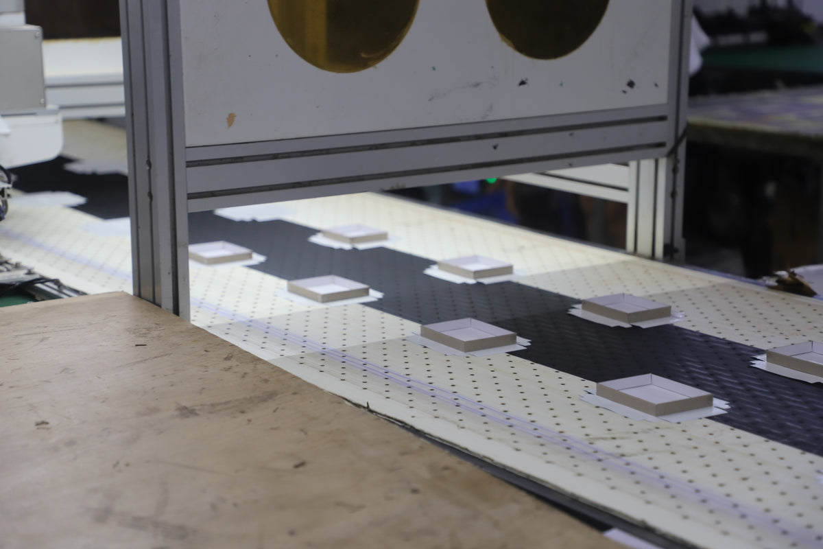 paper box trays moving through automated packaging production equipment