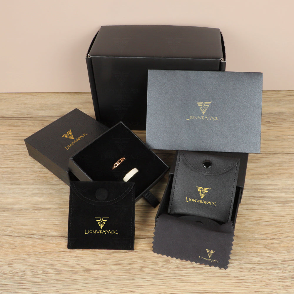 Black jewelry packaging assortment with branded gift boxes, ring box, pouches and polishing cloth.