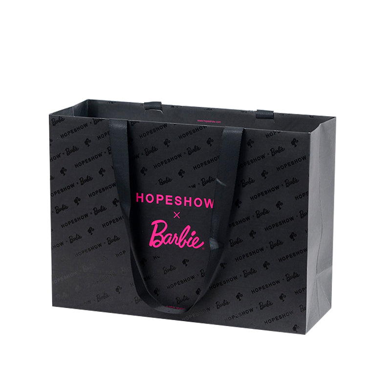 Black custom paper shopping bag with rope handles, a repeating tonal pattern and pink front logo.