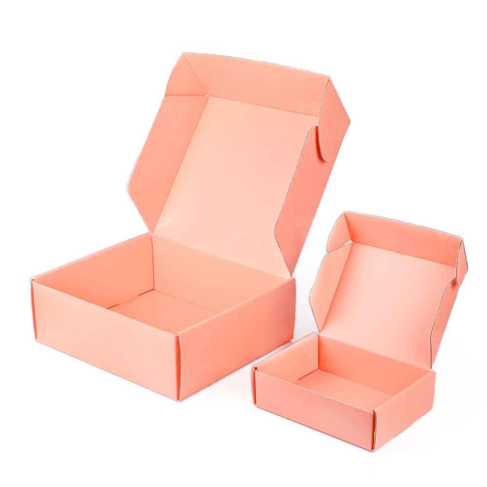 Two open pink folding mailer boxes showing attached tuck-in lids and side flaps.