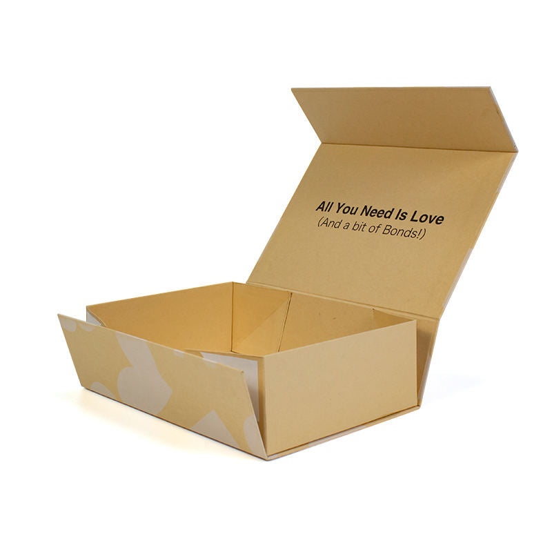 Open kraft folding mailer box with printed interior message and a pale graphic on the outer panels.