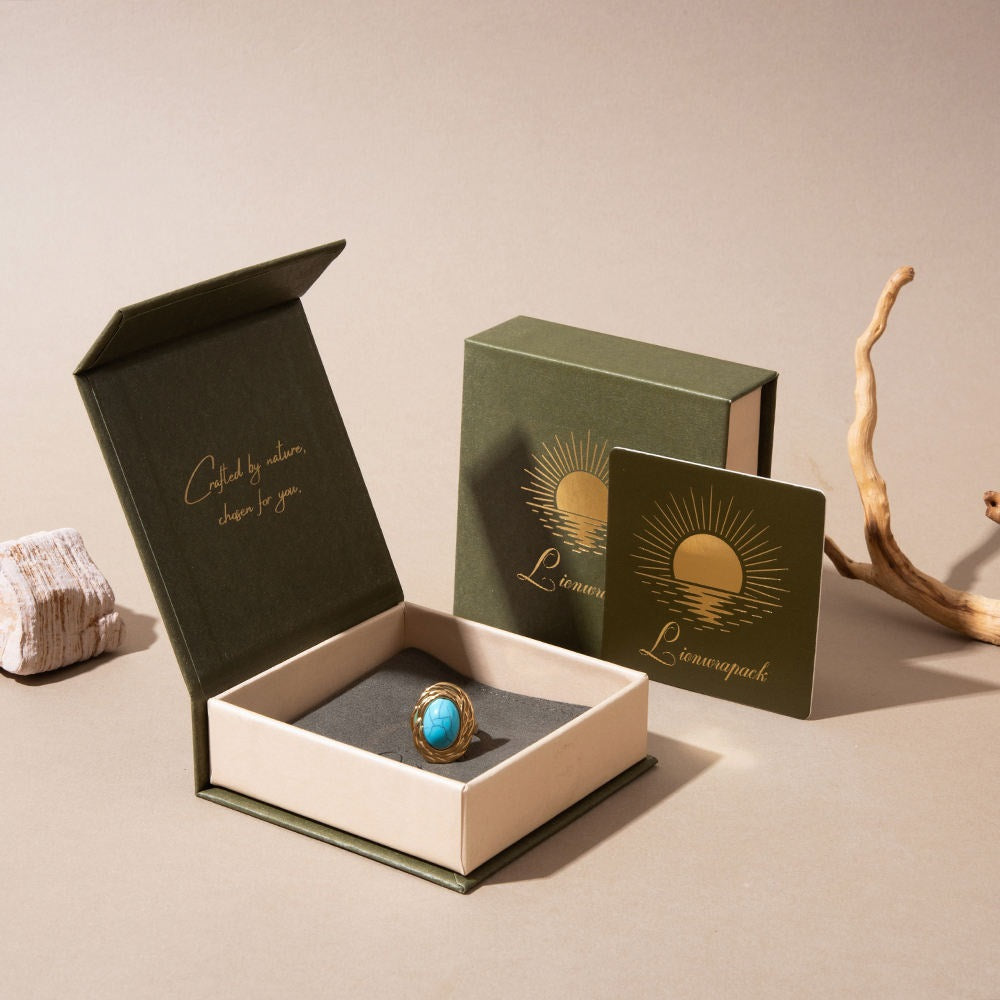 Olive green rigid jewellery box with a turquoise ring and gold printed matching packaging